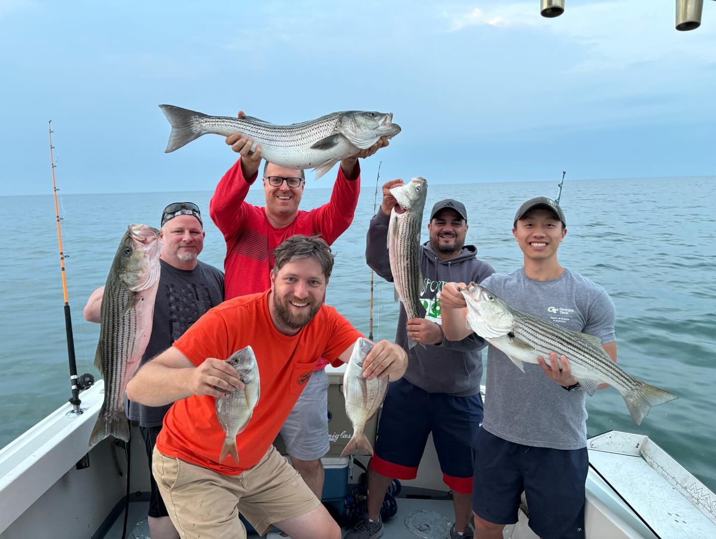 Group of anglers showing off a trophy bluefish on a Mount Sinai charter