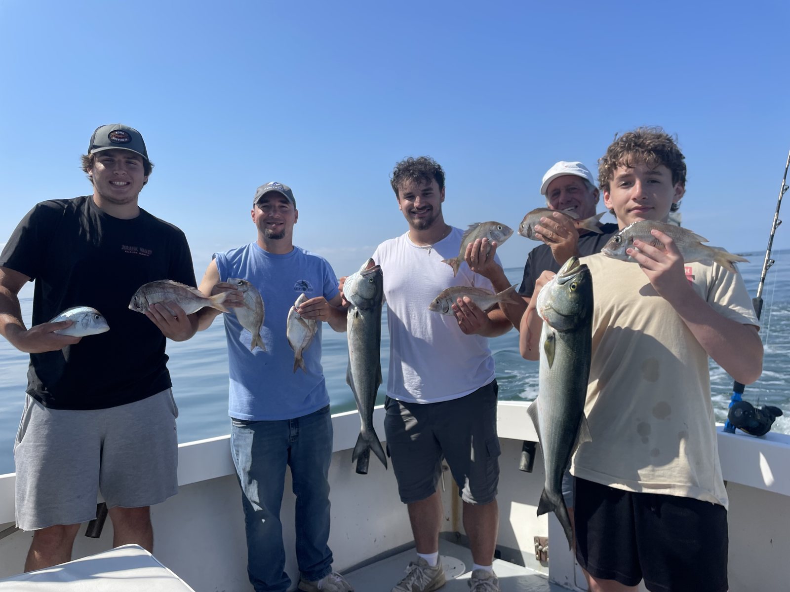 Group of anglers with their catch on a private Mount Sinai fishing charter