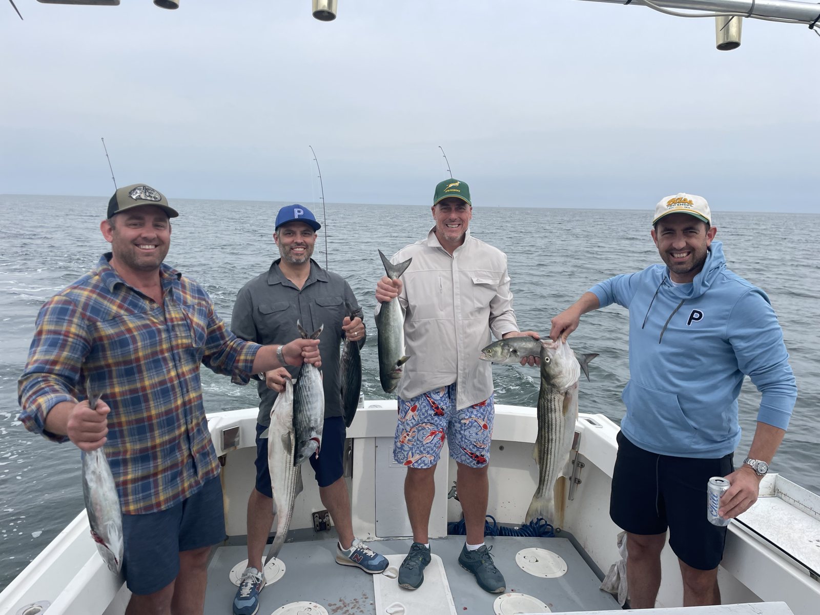 Four anglers in a row with their catch on a Long Island Sound charter
