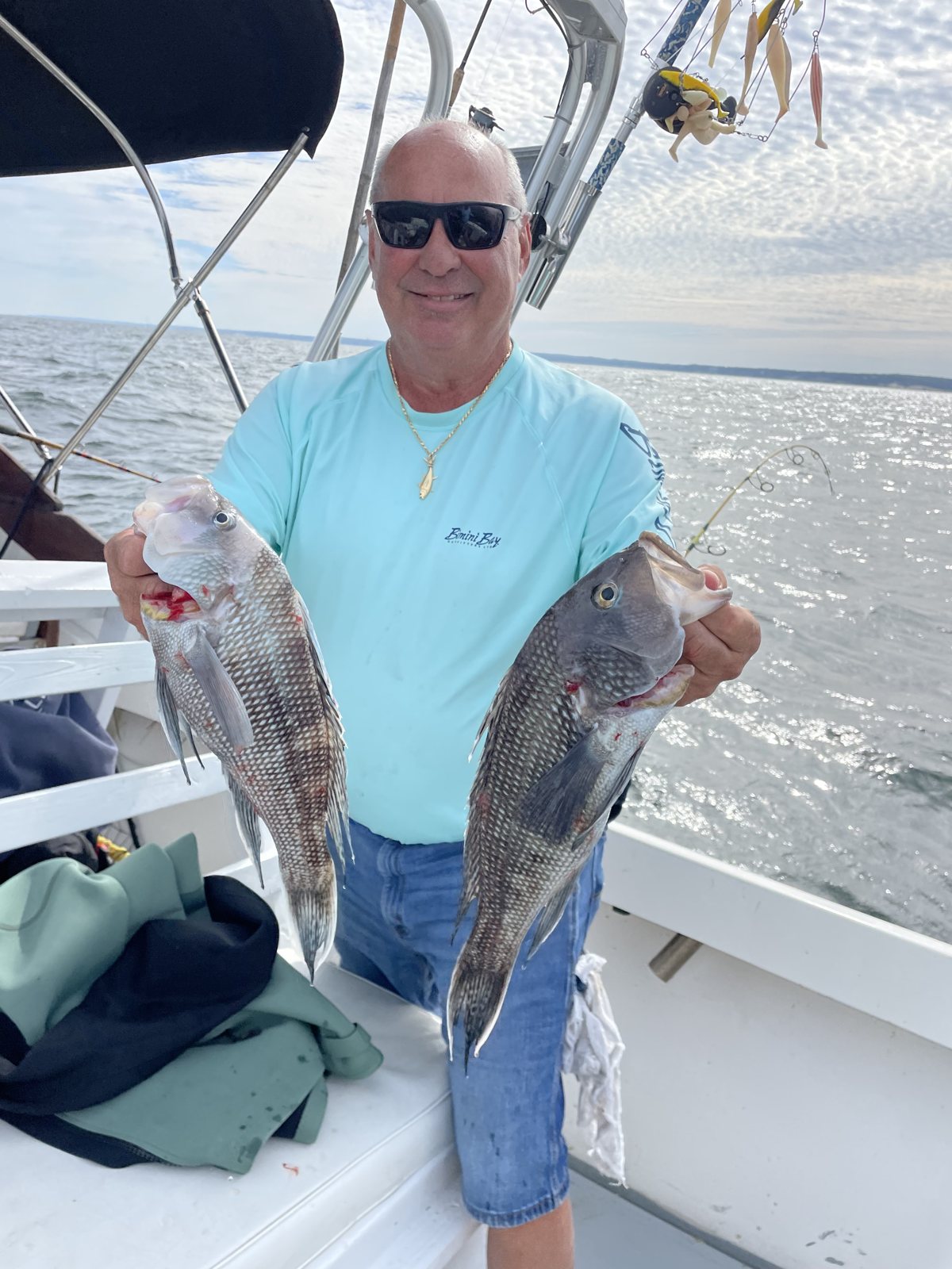 Angler holding a blackfish on a fall bottom-fishing charter