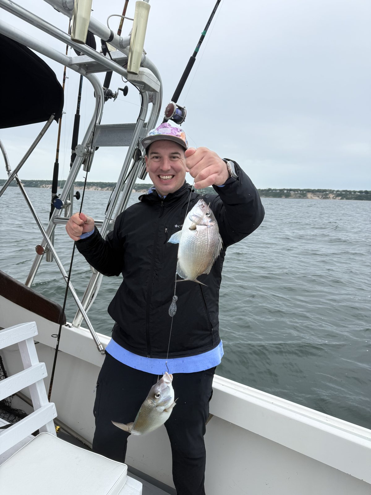 Angler giving a thumbs up with a blackfish on a fall charter