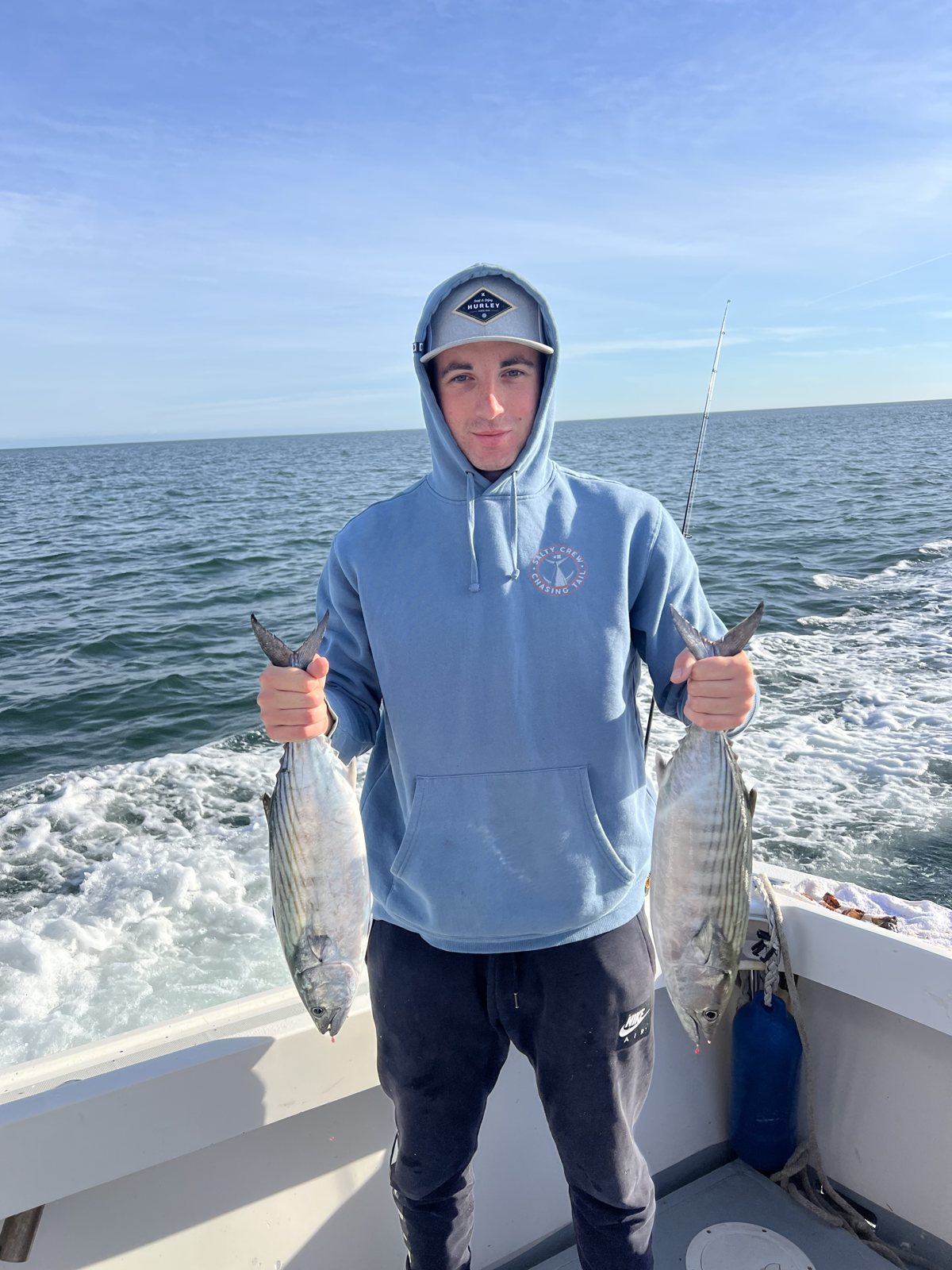 Angler holding a bluefish while underway on the Christina M II